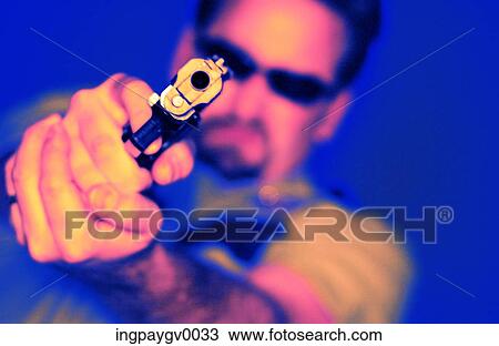 Close-up of a man brandishing a gun View Large Photo Image Stock Image - Close-up of a man brandishing a gun. Fotosearch