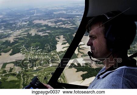 Stock Photo - Close-up of a man flying a helicopter. Fotosearch