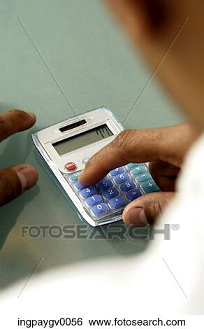 Close-up of a person working on a calculator View Large Photo Image Stock Photograph - Close-up of a person working on a calculator. Fotosearch