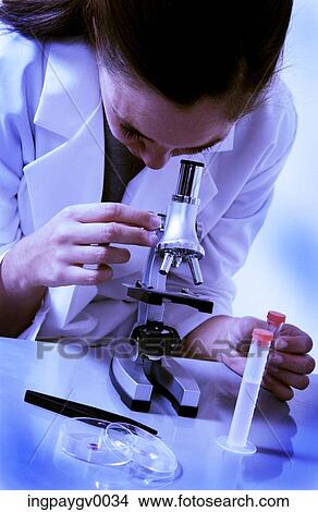 Close-up of a woman looking through a microscope View Large Photo Image Picture - Close-up of a woman looking through a microscope. Fotosearch