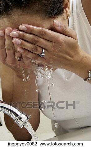 Close-up of a woman washing her face View Large Photo Image Stock Image - Close-up of a woman washing her face. Fotosearch
