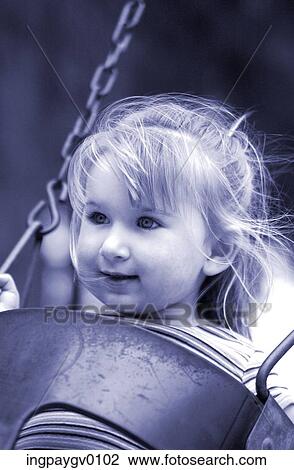 Close-up of a young girl sitting on a swing View Large Photo Image Stock Image - Close-up of a young girl sitting on a swing. Fotosearch