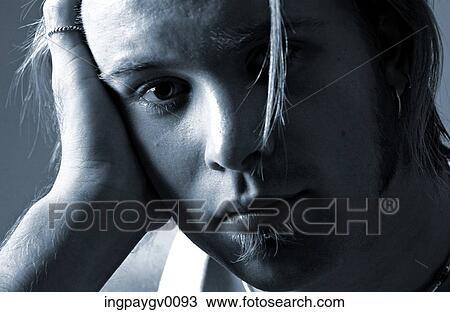 Close-up of a young man looking at camera View Large Photo Image Stock Image - Close-up of a young man looking at camera. Fotosearch