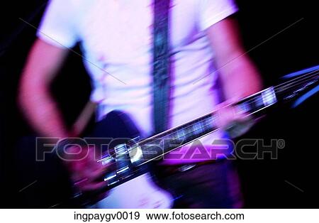 Close-up of a young man playing an electric guitar View Large Photo Image Stock Photo - Close-up of a young man playing an electric guitar. Fotosearch