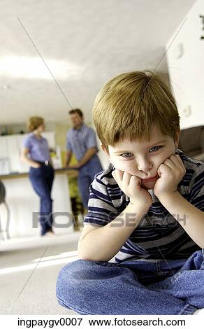 Close-up of an angry looking young boy with his parents in the back ground View Large Photo Image Stock Photo - Close-up of an angry looking young boy with his parents in the back ground. Fotosearch