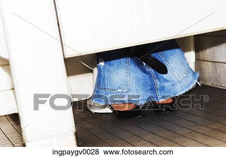 Close-up of the feet of a young woman sitting on a toilet cubical with her skirt around her ankles View Large Photo Image Stock Photo - Close-up of the feet of a young woman sitting on a toilet cubical with her skirt around her ankles. Fotosearch