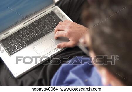 High angle view of a mid adult businessman working on a laptop computer View Large Photo Image Picture - High angle view of a mid adult businessman working on a laptop computer. Fotosearch