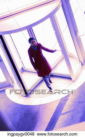 Stock Photo - High angle view of a woman in a revolving door. Fotosearch