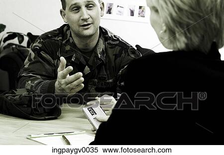 Stock Photography - Rear of a woman talking to a man sitting across her. Fotosearch