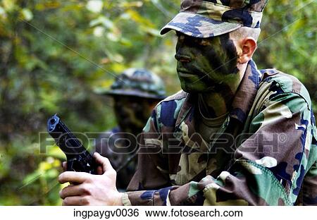 Two soldiers with weapons during a military operation View Large Photo Image Stock Photograph - Two soldiers with weapons during a military operation. Fotosearch