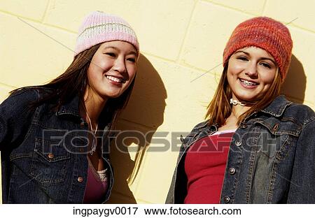 Two young woman wearing woolen caps View Large Photo Image Stock Photo - Two young woman wearing woolen caps. Fotosearch