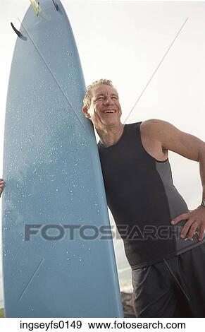 Aging Male Surfer Laughing on the Beach View Large Photo Image Stock Photo - Aging Male Surfer Laughing on the Beach. Fotosearch