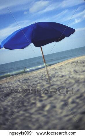 Blue Umbrella On A Warm Sandy Beach View Large Photo Image Stock Image - Blue Umbrella On A Warm Sandy Beach. Fotosearch