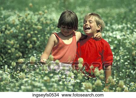 Boy and Girl Playing in a Field View Large Photo Image Picture - Boy and Girl Playing in a Field. Fotosearch