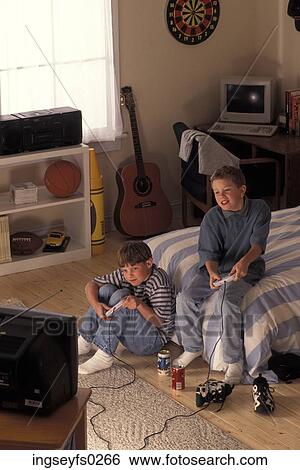 Boys Playing Video Games In Bedroom View Large Photo Image Stock Photograph - Boys Playing Video Games In Bedroom. Fotosearch