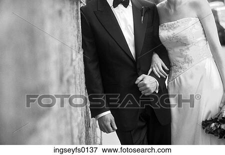 Bride and Groom Leaning Against A Wall View Large Photo Image Stock Photo - Bride and Groom Leaning Against A Wall. Fotosearch