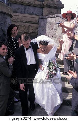 Picture - Bride And Groom Running Down Steps Of Church. Fotosearch