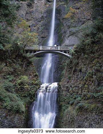 Stock Image - Bridge Crossing Mountain Waterfall. Fotosearch