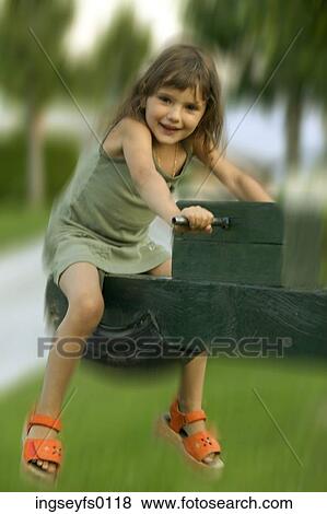 Caucasian Girl Riding A Seesaw View Large Photo Image Stock Photo - Caucasian Girl Riding A Seesaw. Fotosearch