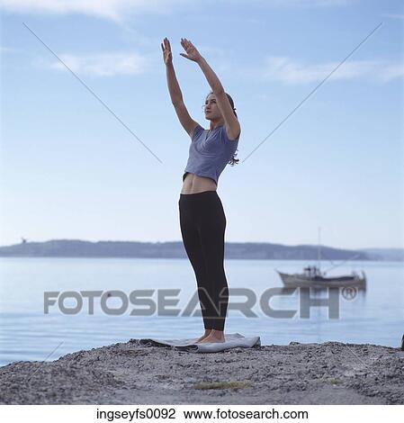 Caucasian Woman Doing Yoga On Lake Shore View Large Photo Image Stock Image - Caucasian Woman Doing Yoga On Lake Shore. Fotosearch