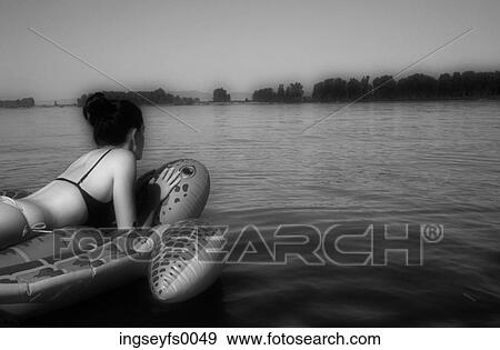 Caucasian Woman Floating On An Inflatable Turtle In A Mountain Lake View Large Photo Image Stock Photo - Caucasian Woman Floating On An Inflatable Turtle In A Mountain Lake. Fotosearch