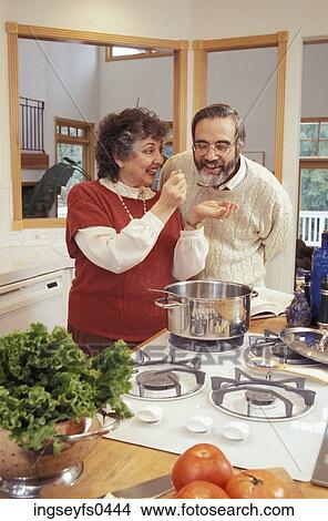 Picture - Couple Cooking in their Kitchen. Fotosearch