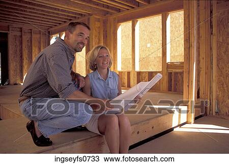 Stock Image - Couple Looking At Plans. Fotosearch
