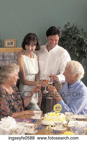 Couple with Parents Toasting Each Other View Large Photo Image Stock Photo - Couple with Parents Toasting Each Other. Fotosearch