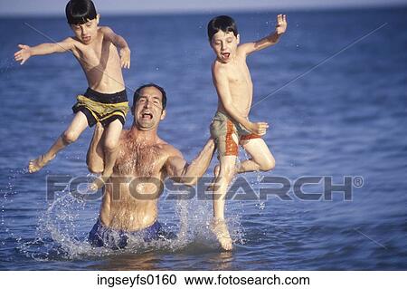 Dad Lifting Laughing Boys Out Of Ocean View Large Photo Image Stock Image - Dad Lifting Laughing Boys Out Of Ocean. Fotosearch