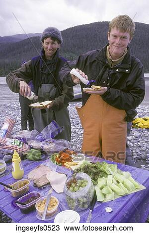 Stock Image - Eating a Picnic by the River. Fotosearch