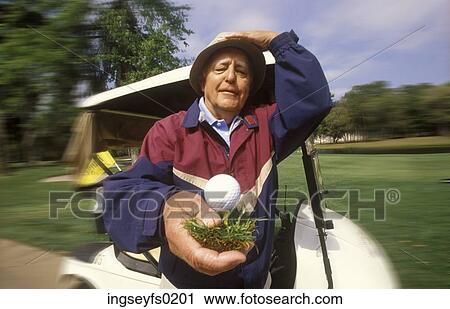 Elderly Man Holding Golf Ball On Tee In Front Of Golf Cart View Large Photo Image Stock Image - Elderly Man Holding Golf Ball On Tee In Front Of Golf Cart. Fotosearch