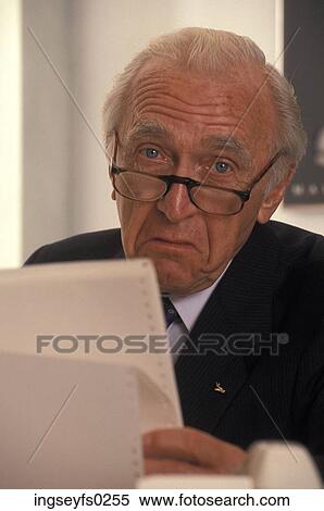Elderly Man Looking At Printouts And Frowning View Large Photo Image Stock Photography - Elderly Man Looking At Printouts And Frowning. Fotosearch