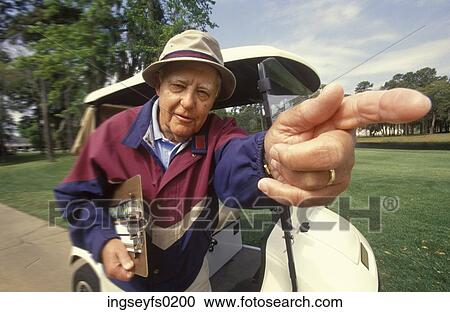 Elderly Man Walking Next To Golf Cart And Pointing Forward View Large Photo Image Stock Image - Elderly Man Walking Next To Golf Cart And Pointing Forward. Fotosearch