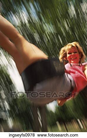 Girl Swinging in a Blur View Large Photo Image Stock Photo - Girl Swinging in a Blur. Fotosearch