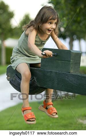 Laughing Caucasian Girl Riding A Seesaw View Large Photo Image Stock Photo - Laughing Caucasian Girl Riding A Seesaw. Fotosearch