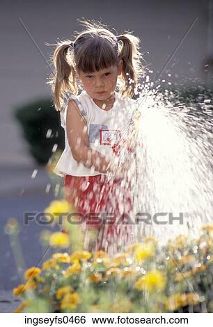 Little Girl Spraying a Garden Hose View Large Photo Image Stock Photograph - Little Girl Spraying a Garden Hose. Fotosearch