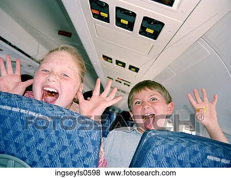 Little Kids Having Fun on an Airplane View Large Photo Image Stock Photo - Little Kids Having Fun on an Airplane. Fotosearch