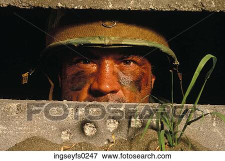 Stock Photo - Male Soldier Staring Out Of Bunker. Fotosearch