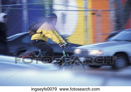 Man Bicycling Through City Traffic View Large Photo Image Stock Photo - Man Bicycling Through City Traffic. Fotosearch
