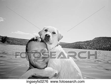 Man Hugging Dog In Mountain Lake View Large Photo Image Stock Photograph - Man Hugging Dog In Mountain Lake. Fotosearch