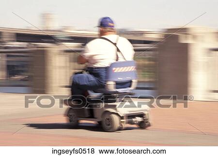 Man Riding a Rascal View Large Photo Image Stock Photo - Man Riding a Rascal. Fotosearch