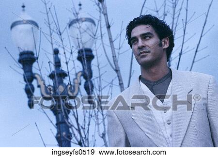Man Standing By Lamppost View Large Photo Image Stock Photo - Man Standing By Lamppost. Fotosearch