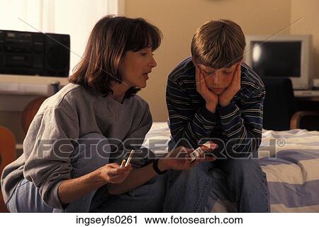 Stock Image - Mother Lecturing Son About Smoking. Fotosearch