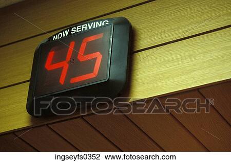 Stock Image - Now Serving Sign. Fotosearch
