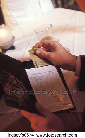 Paying a Restaurant Bill with a Credit Card View Large Photo Image Picture - Paying a Restaurant Bill with a Credit Card. Fotosearch