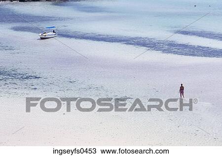 Person and Boat in Shallow Tropical Water View Large Photo Image Stock Image - Person and Boat in Shallow Tropical Water. Fotosearch