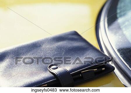 Pocketbook on the Hood of a Car View Large Photo Image Stock Image - Pocketbook on the Hood of a Car. Fotosearch