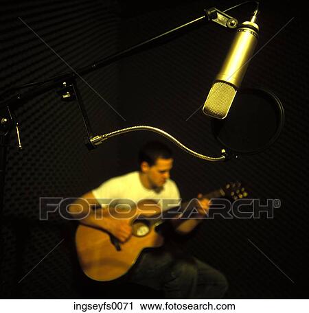 Stock Image - Recording A Guitar Player In The Studio. Fotosearch