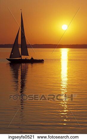 Sailboat Sailing at Sunset View Large Photo Image Stock Image - Sailboat Sailing at Sunset. Fotosearch