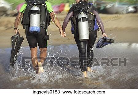 Scuba Diving Couple Walking Out of Ocean Holding Hands View Large Photo Image Stock Image - Scuba Diving Couple Walking Out of Ocean Holding Hands. Fotosearch